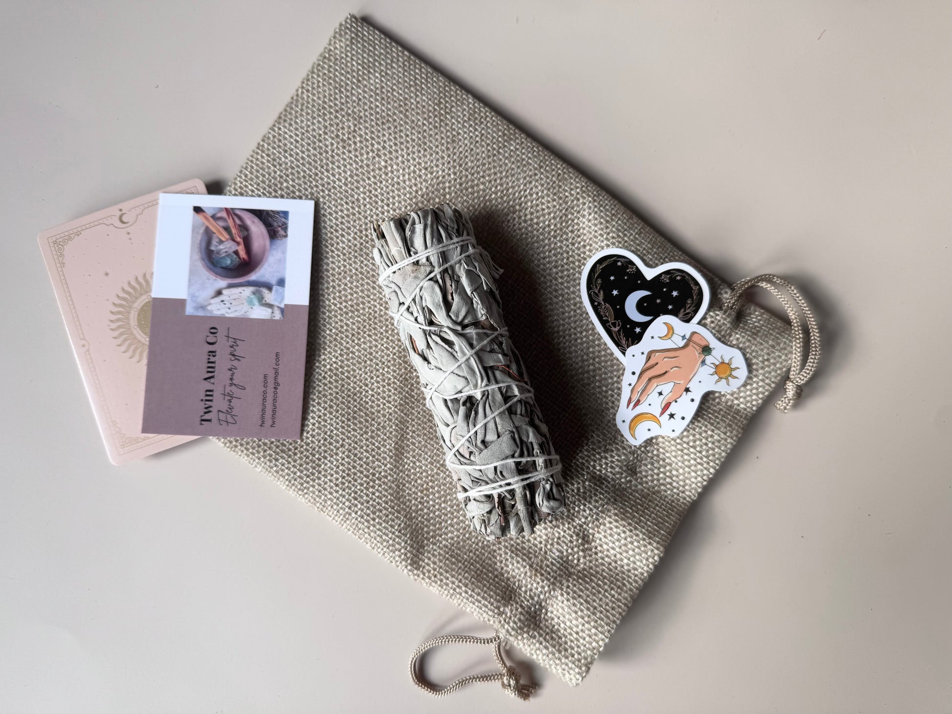Sage bundle, cards, and stickers on a textured surface